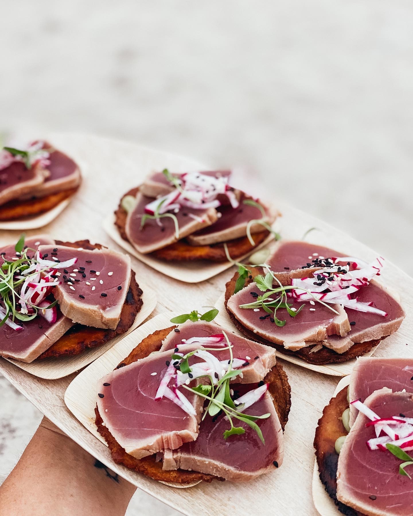 Beach gathering with rattan seating and fire pit