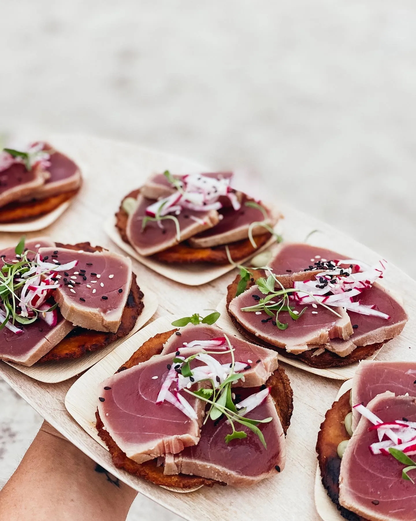 Beach gathering with rattan seating and fire pit