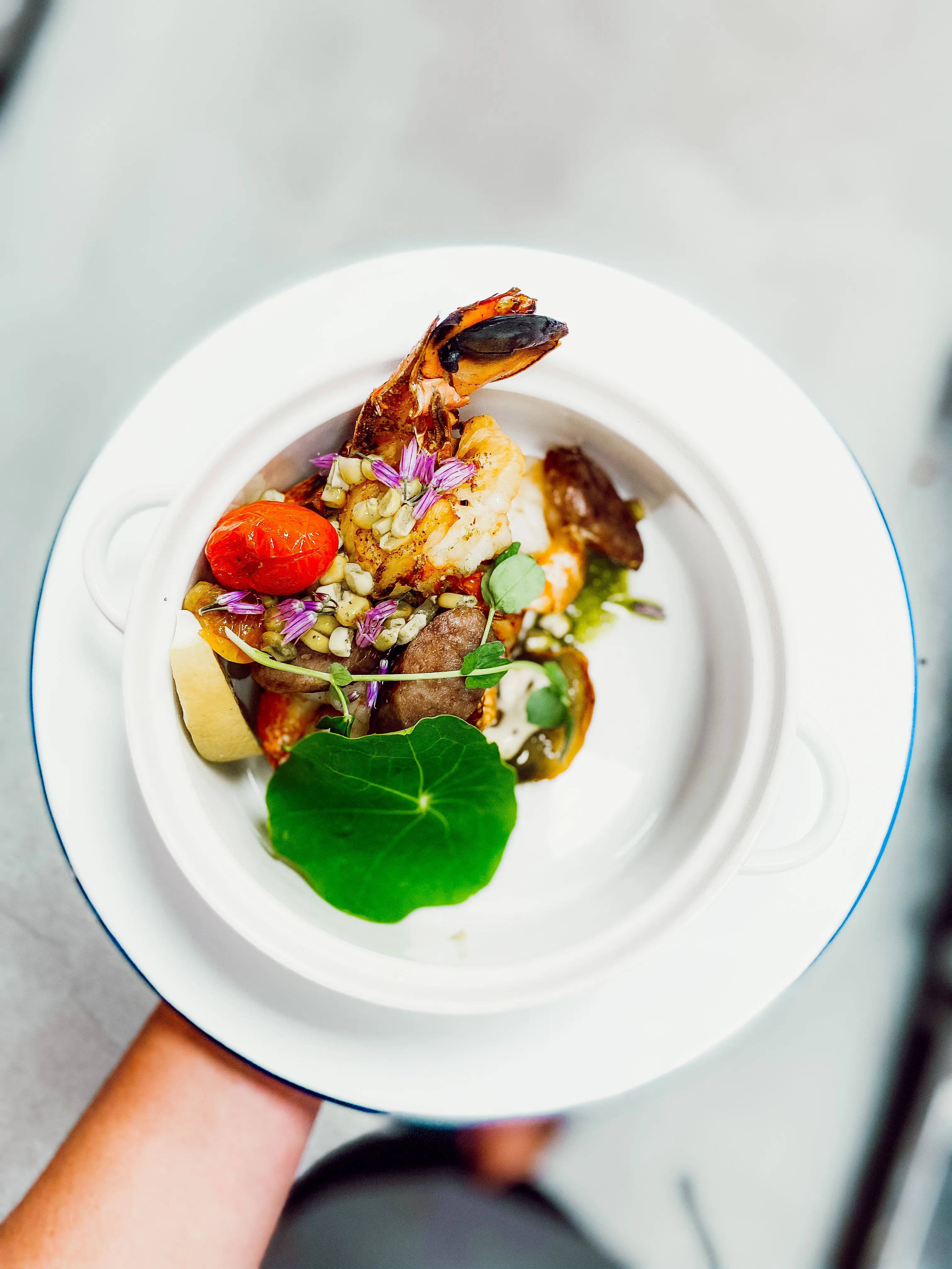 Chef plating tuna appetizers on wooden boards