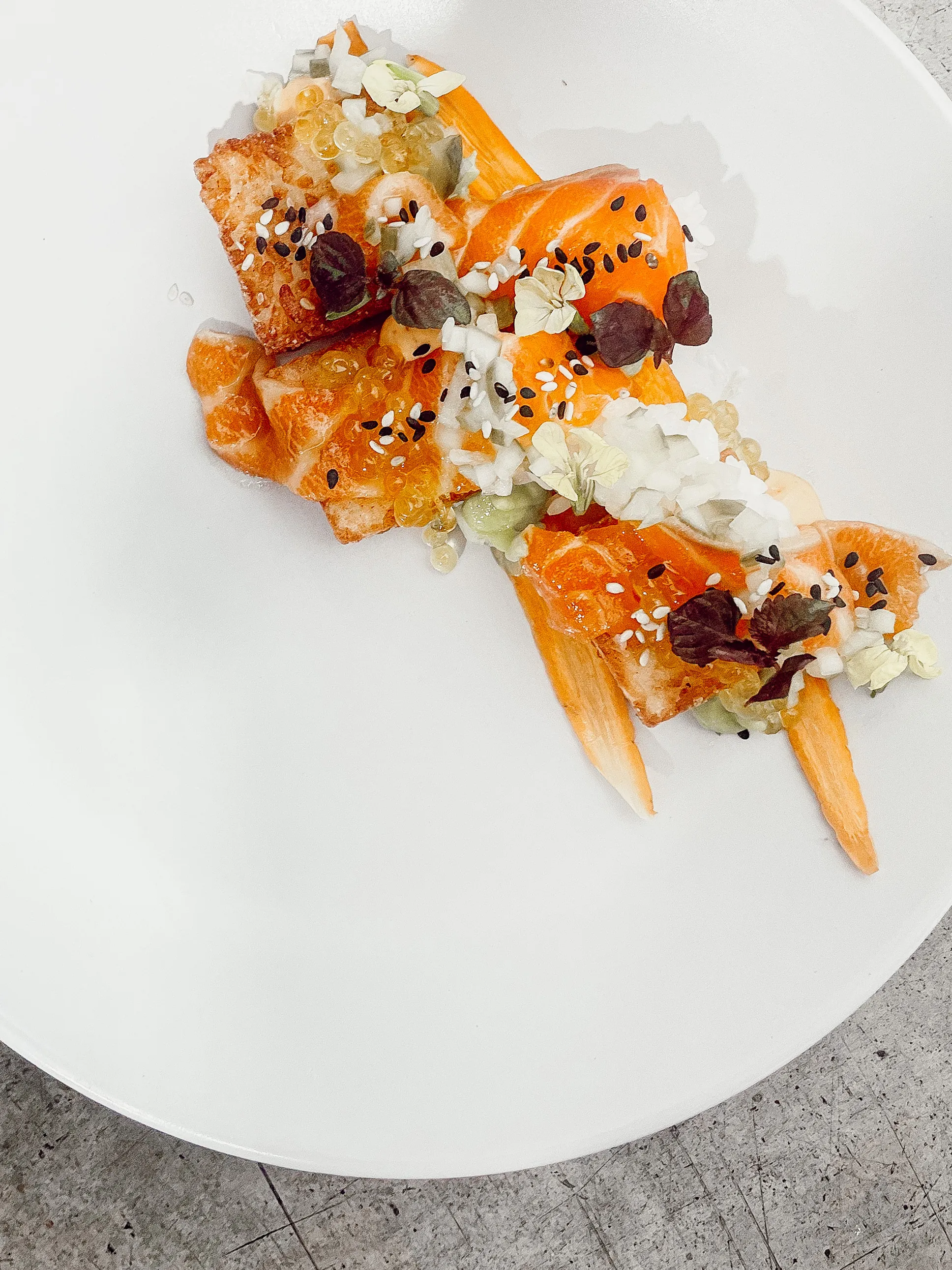 Bright salmon course styled on a minimalist plate