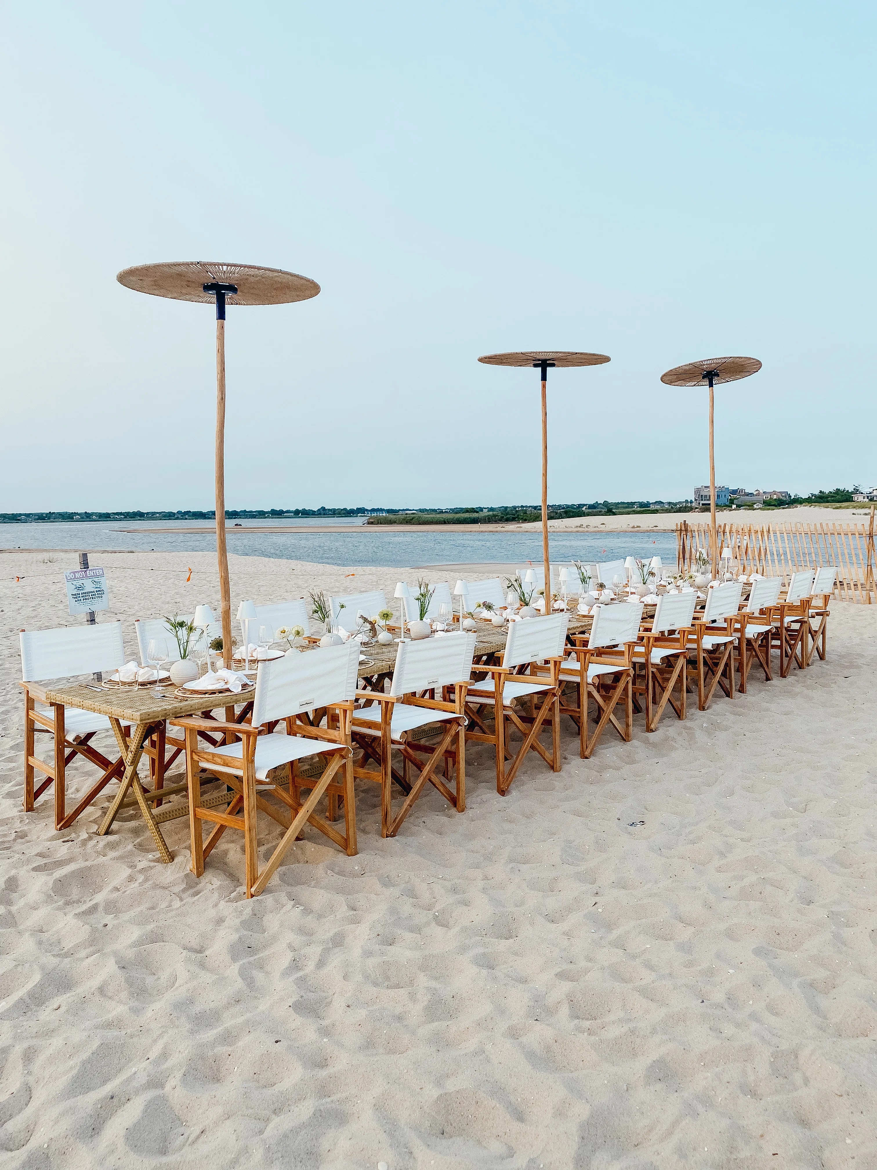Long beach table setup near the waterline