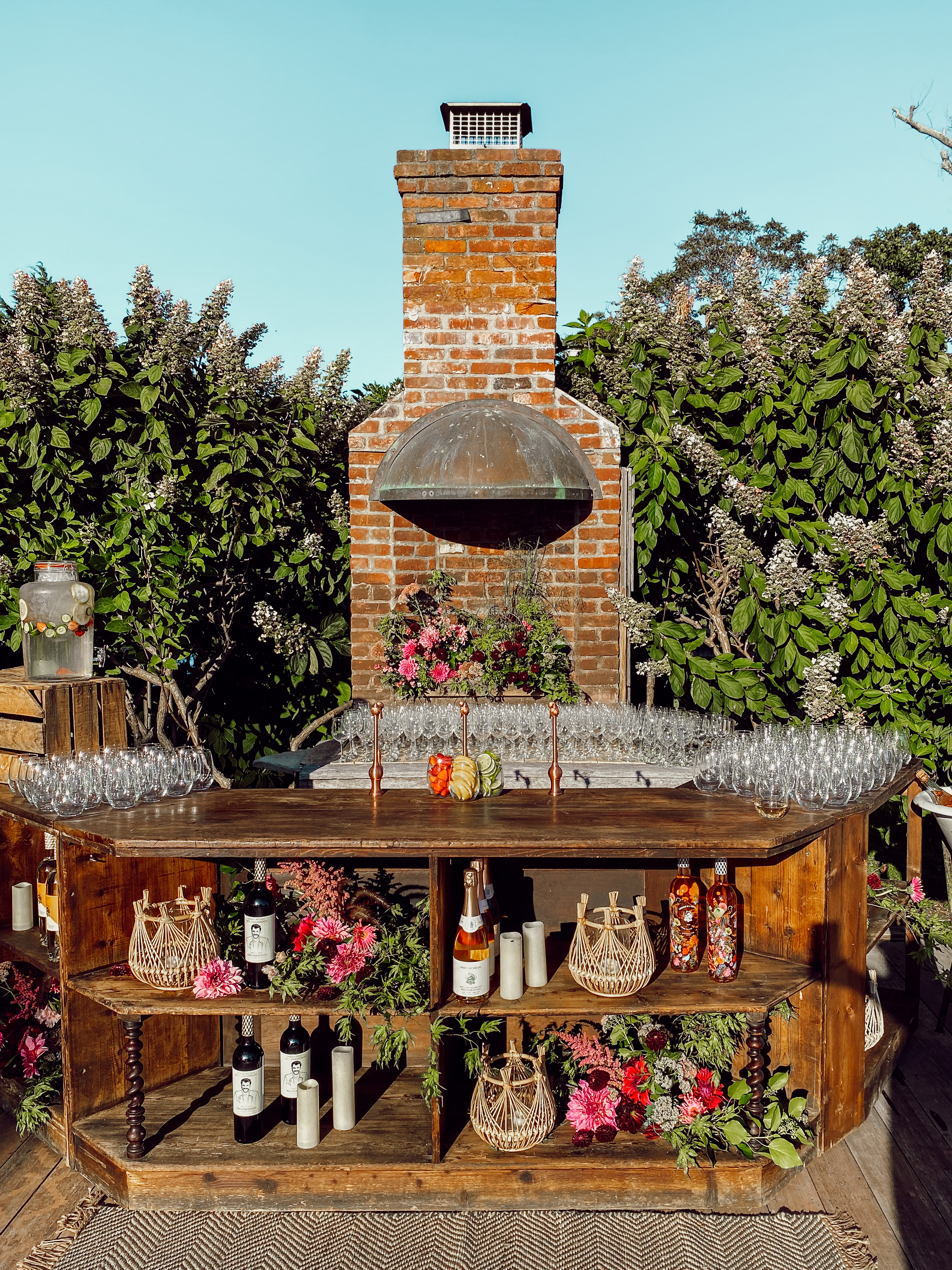 Rustic cocktail station with florals and glassware