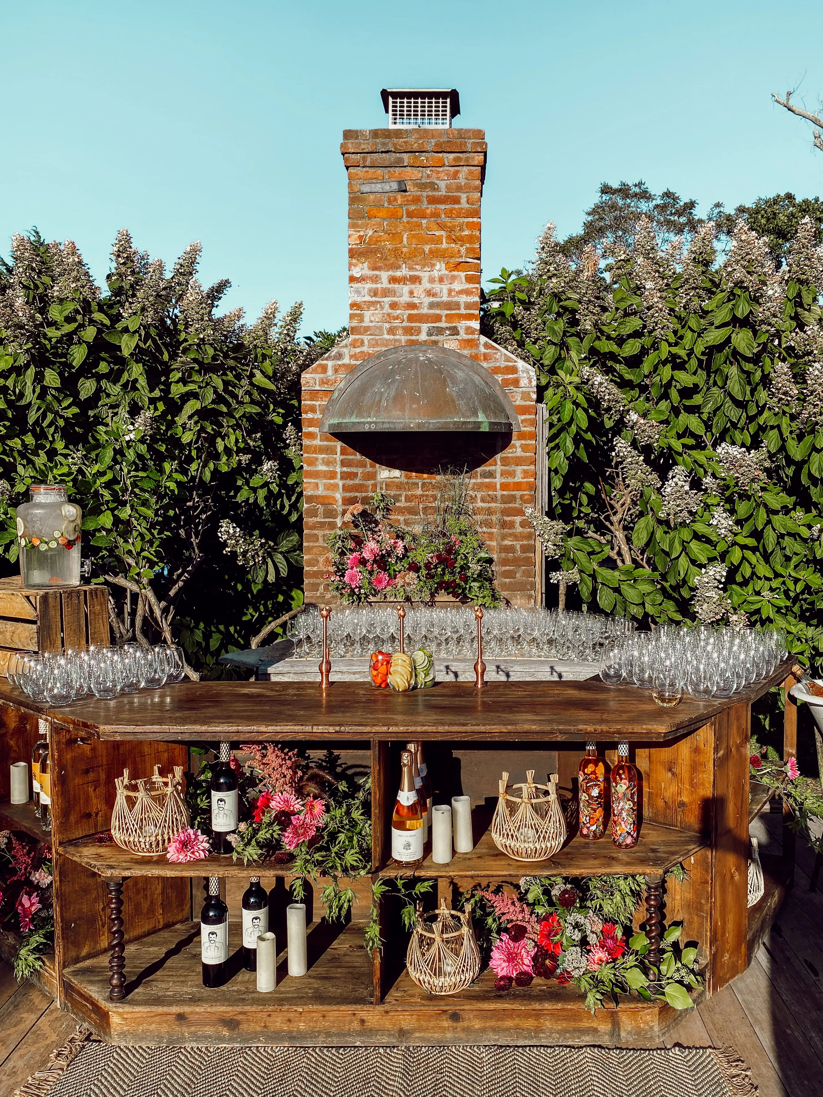Rustic cocktail station with florals and glassware