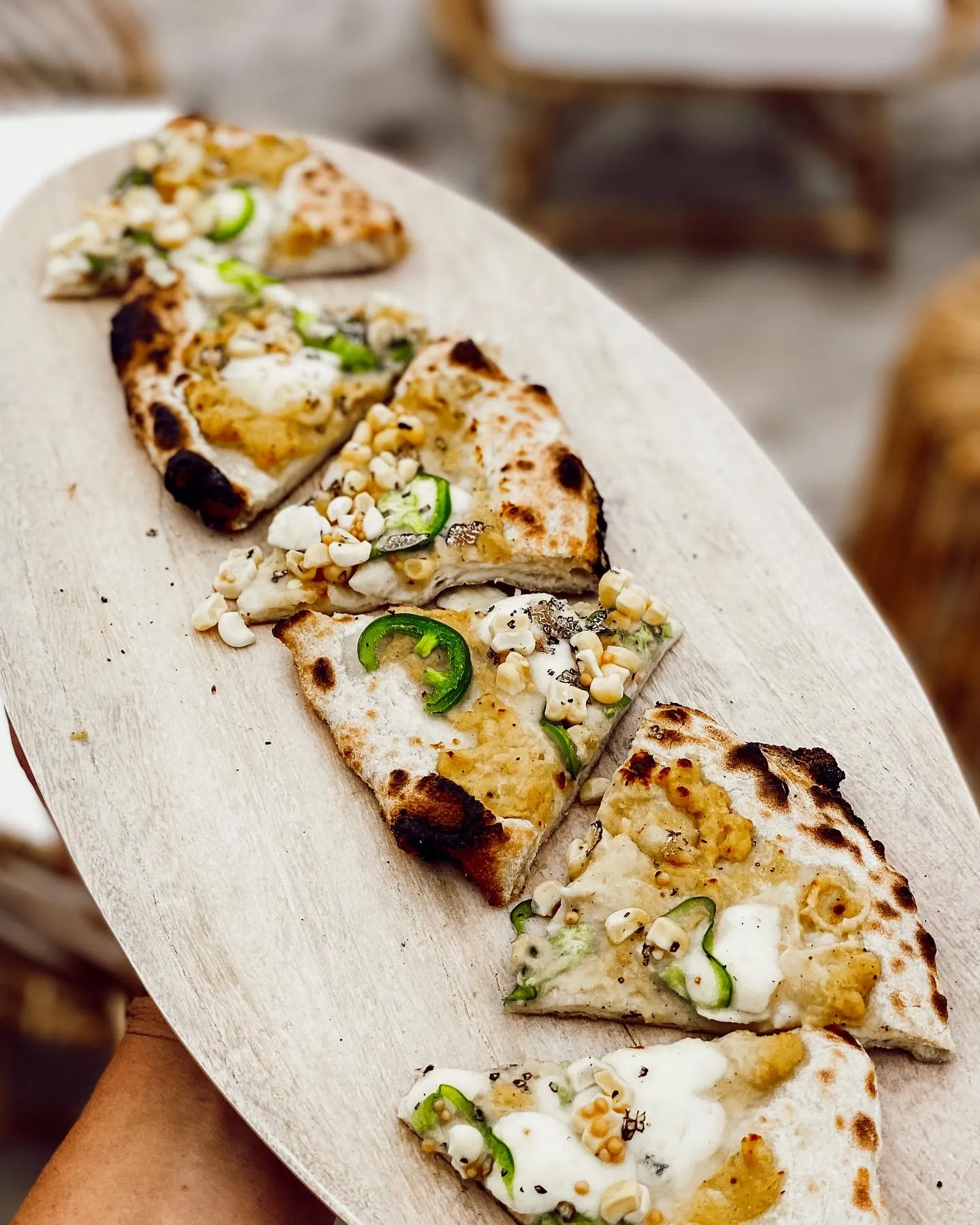 Slider-style bite served on a wooden board