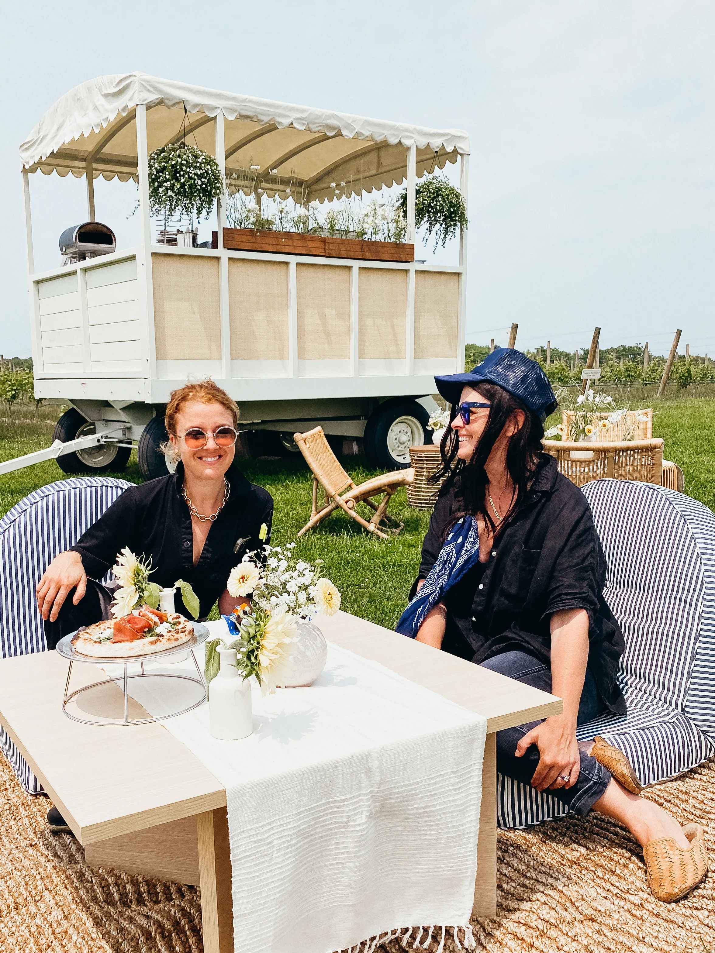 Guests enjoying lunch beside the vintage white cart